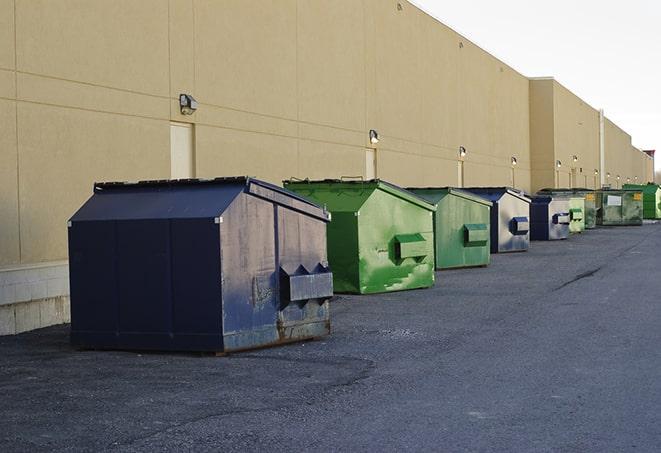 workers clearing construction waste into dumpsters in Atlanta, IN